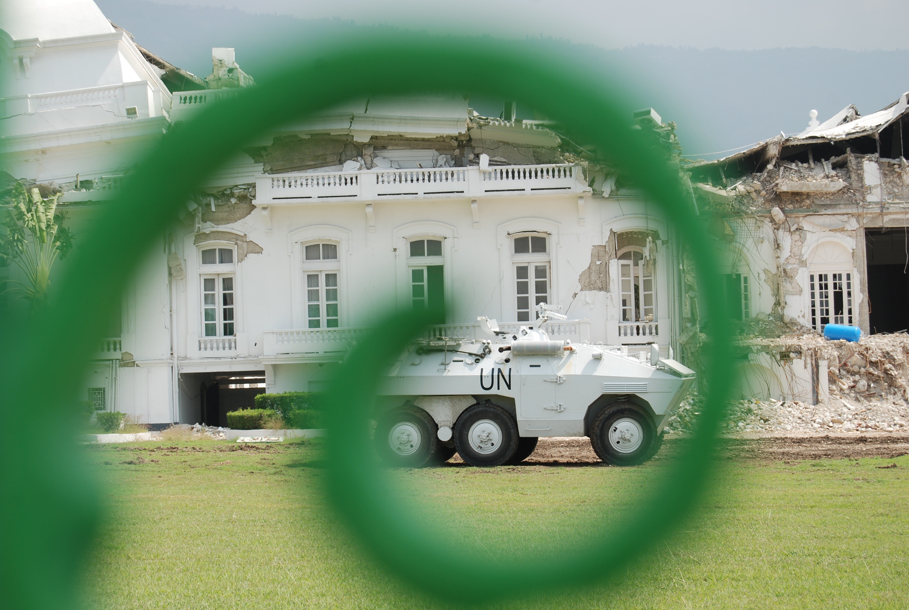 A UN tank in front of the Presidential Palace in Port-au-Prince, Haiti; the Palace shows signs of severe damage from the 2010 earthquake.