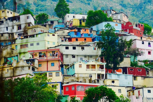 Colorful apartment buildings on a hillside in Haiti. 