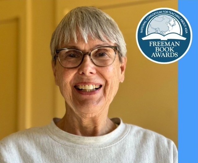 A woman with short grey hair and glasses, next to a blue logo reading "National Consortium for Teaching about Asia: Freeman Book Awards."