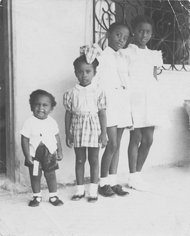 A black and white photo of the four Trouillot siblings as children.